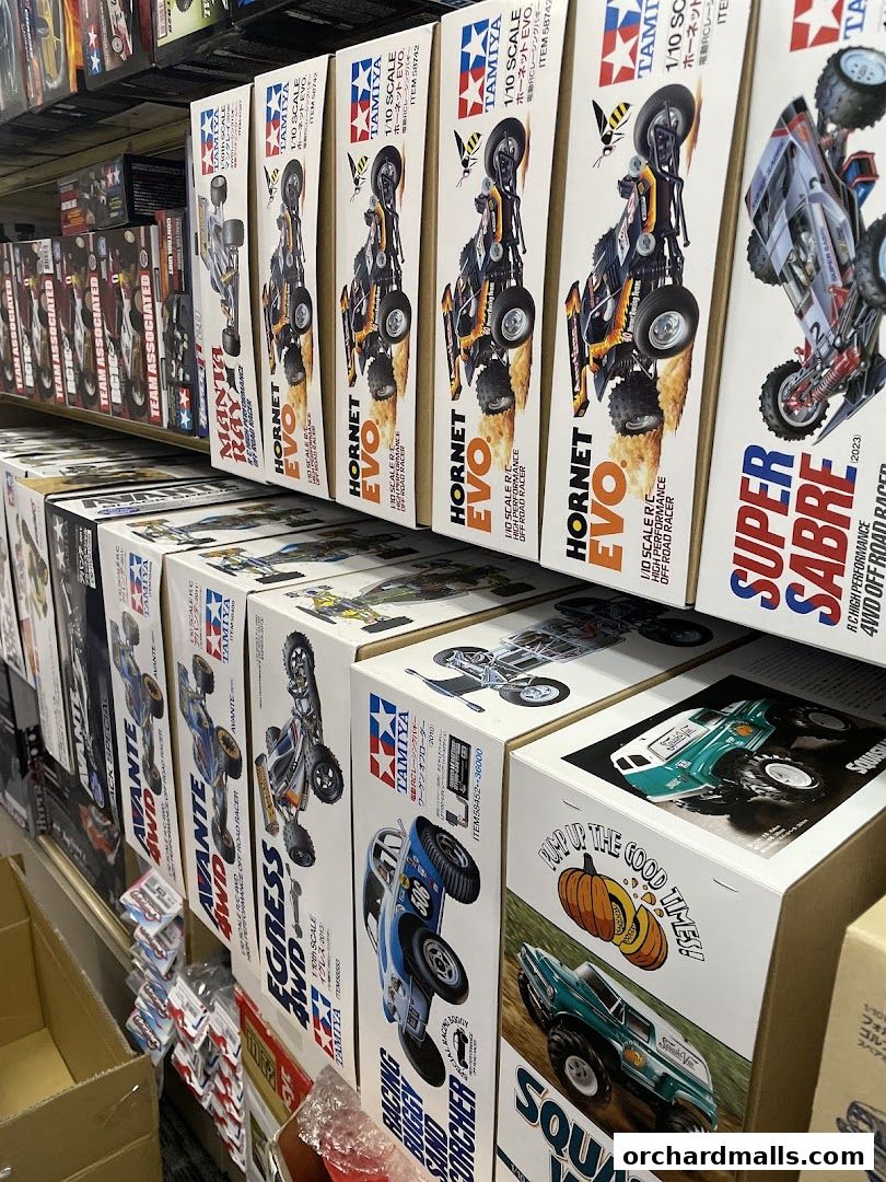 Shelves filled with various model car kits, primarily Tamiya brand, showcasing different racing vehicles.