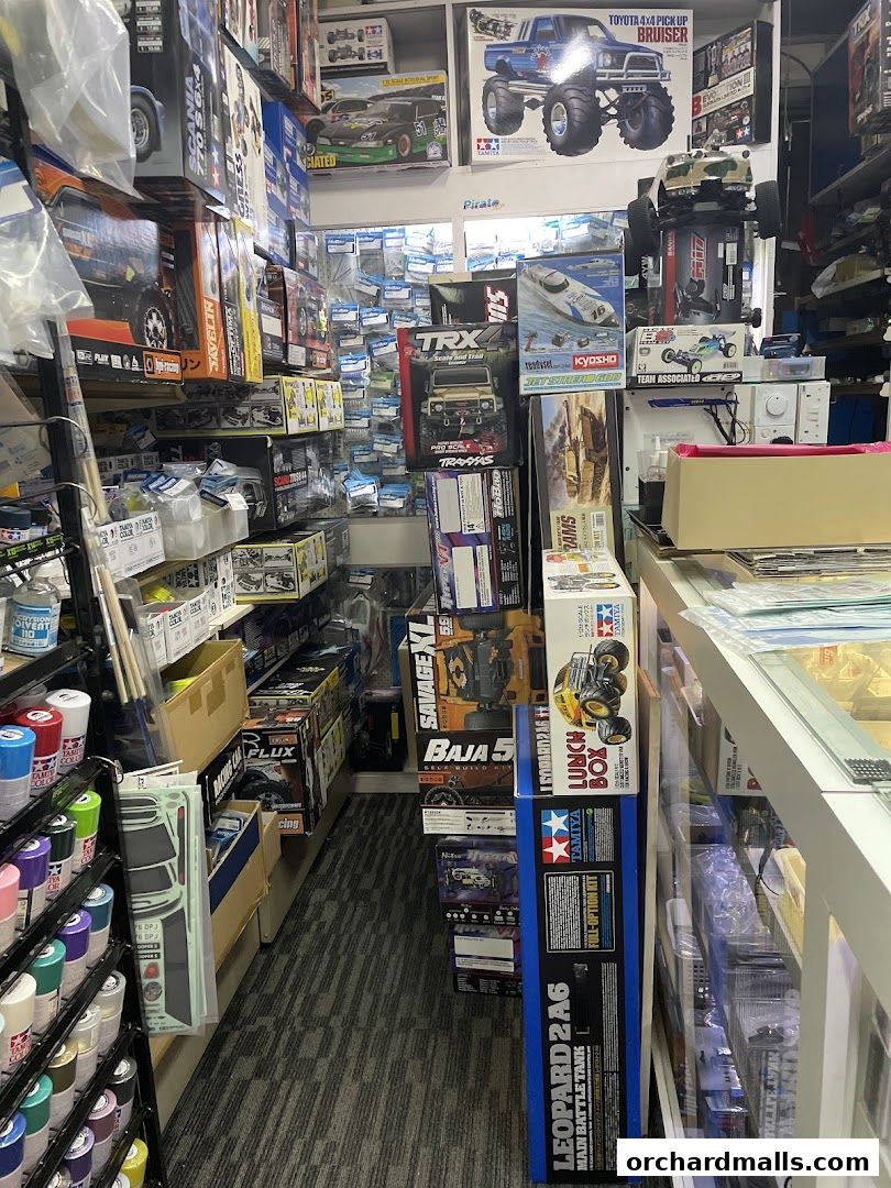 A retail shop interior filled with model kits, RC cars, and hobby supplies.