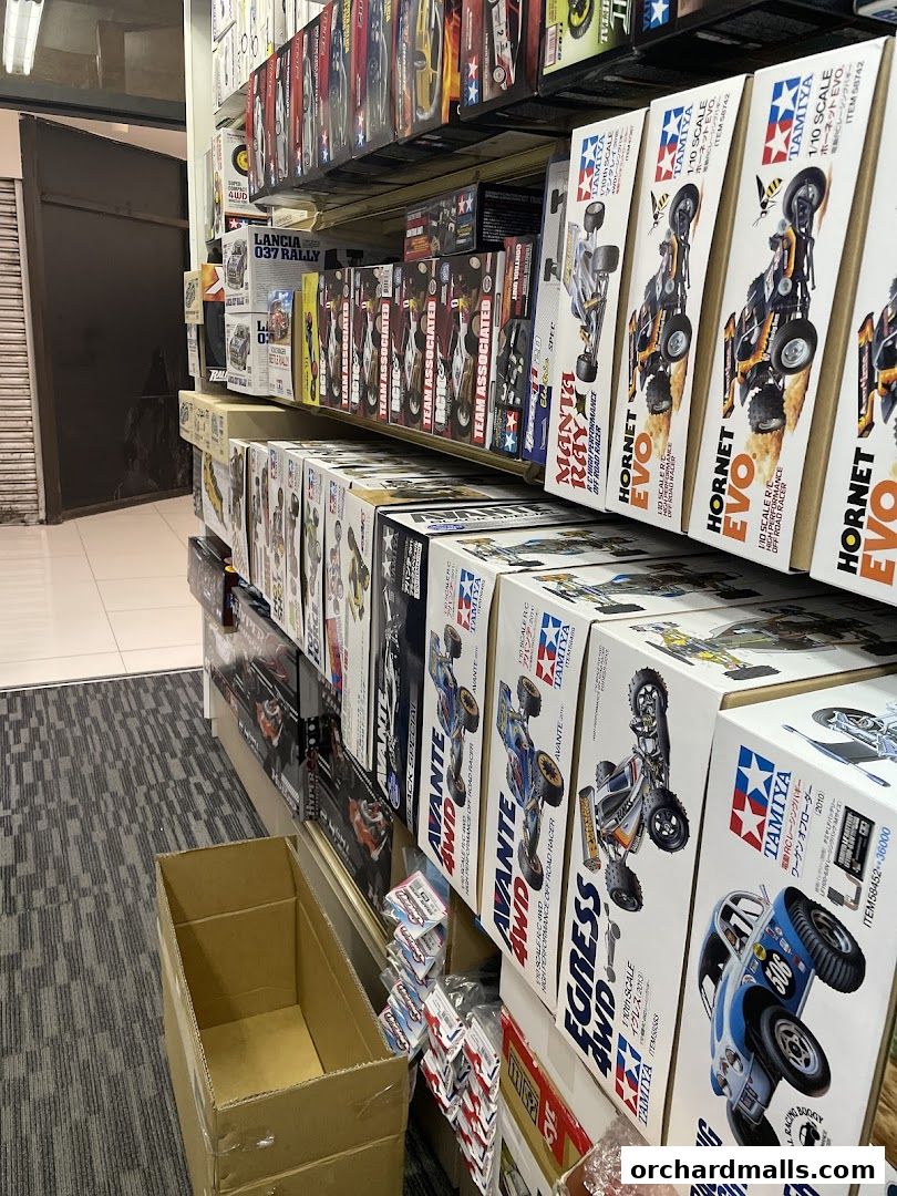 Shelves stocked with various Tamiya model car kits, including off-road racers.