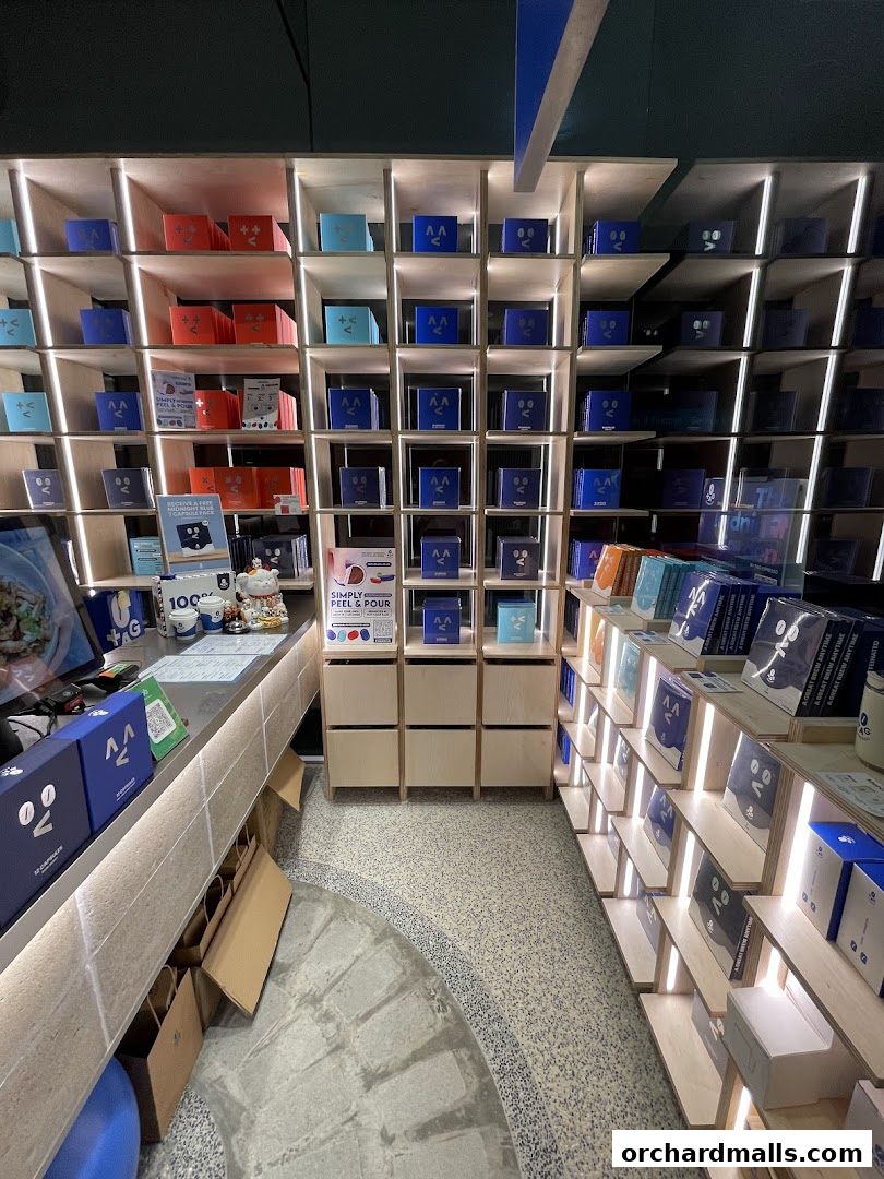 Interior of TAG Espresso shop showcasing shelves filled with coffee products and a counter.