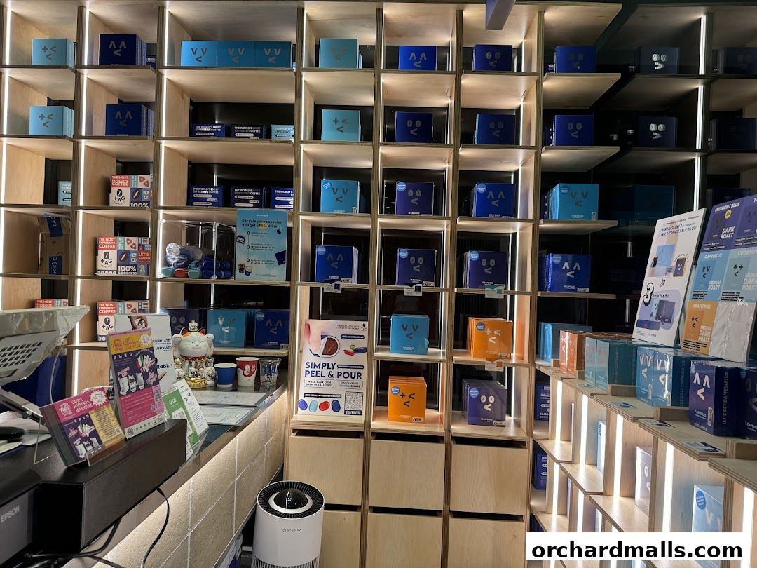 Interior of TAG Espresso shop with shelves displaying coffee products and branded merchandise.