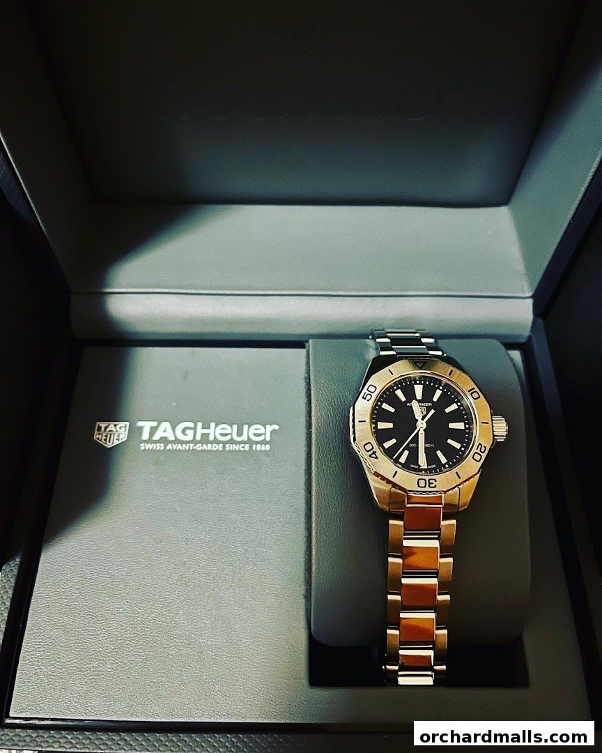 A TAG Heuer watch displayed in its branded box with accompanying literature.