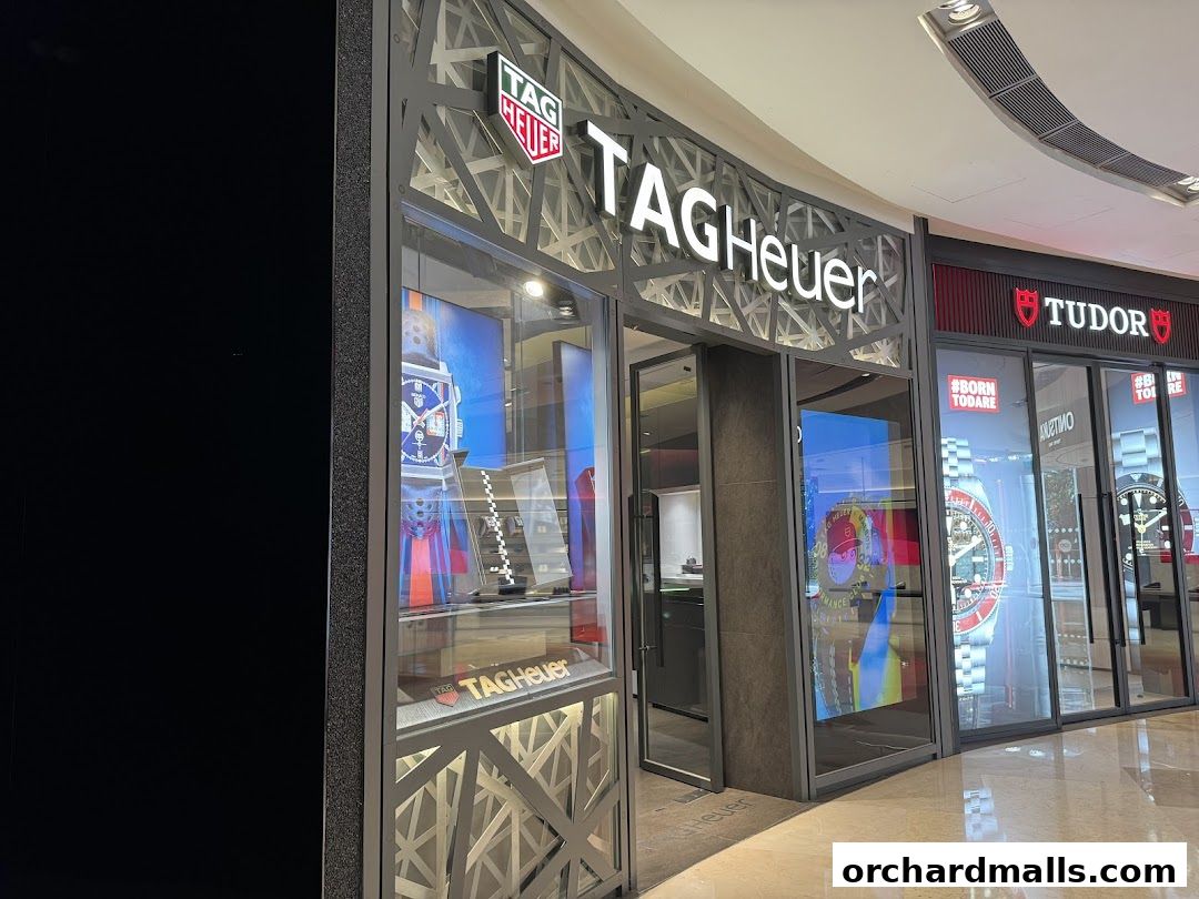 The exterior of a TAG Heuer watch shop with illuminated signage and display windows.
