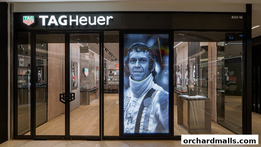 The exterior of a TAG Heuer watch shop with a large display featuring a portrait.