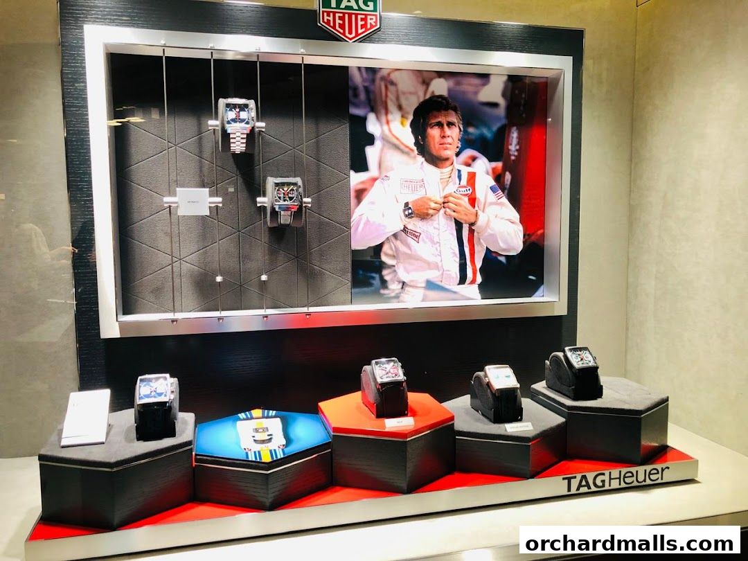 TAG Heuer watches displayed in a modern shop window with a racing theme.