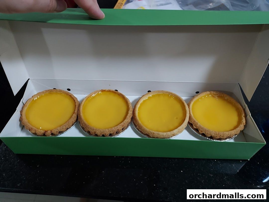 A box of four golden egg tarts from Tai Cheong Bakery.