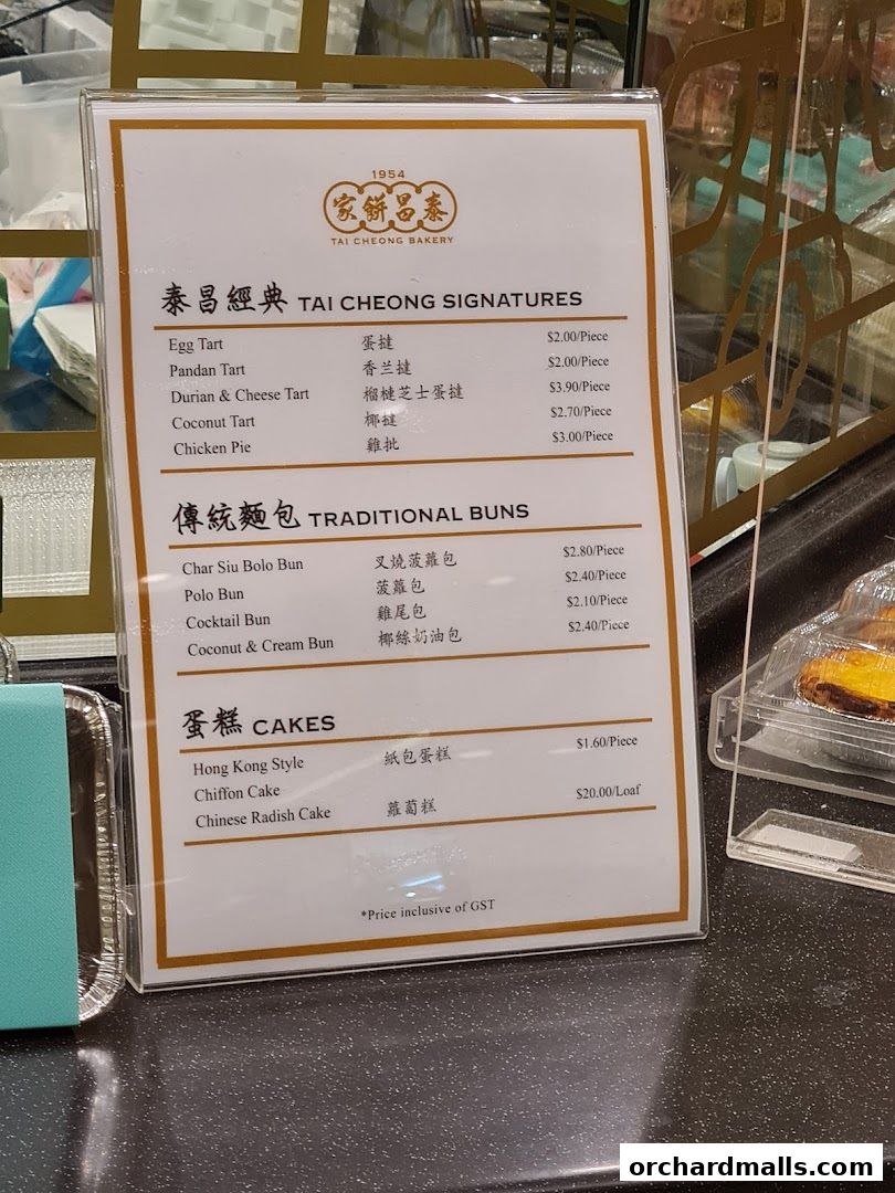 A menu board from Tai Cheong Bakery showcasing signatures, traditional buns, and cakes with prices.