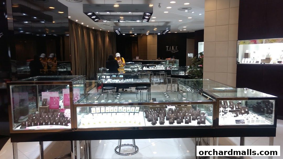 Interior view of a jewelry store with display cases filled with necklaces and rings.