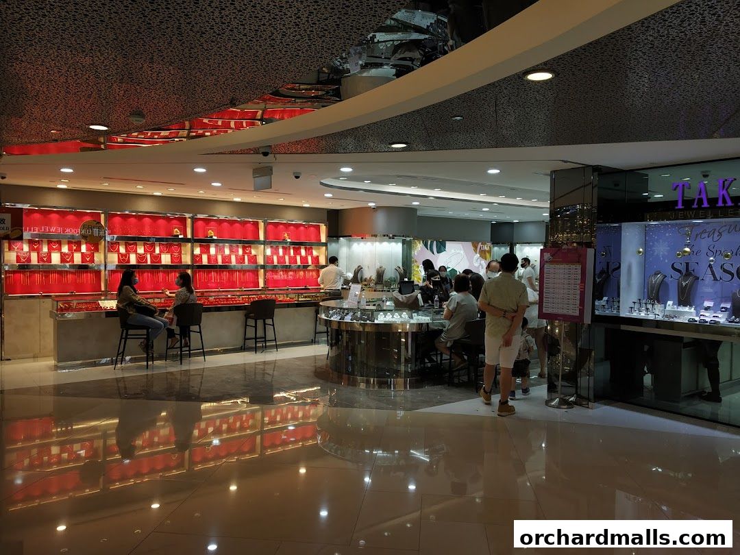 Interior view of a jewelry store with displays of necklaces and customers browsing.