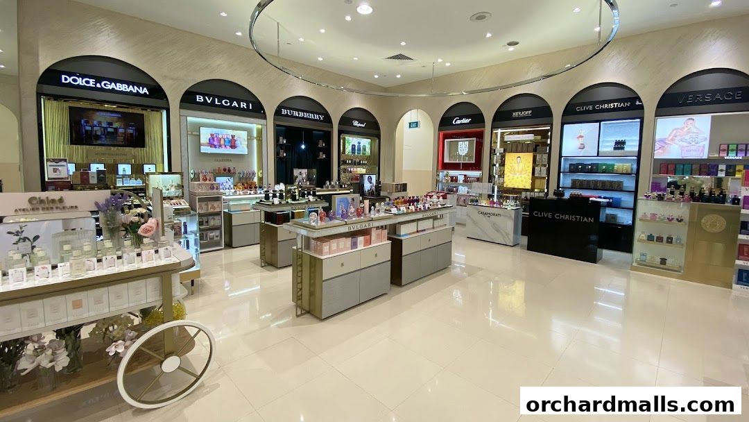 Interior view of a luxury perfume and cosmetics section in a department store.