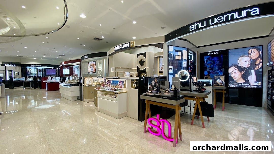Interior view of a luxury cosmetics section in a department store.