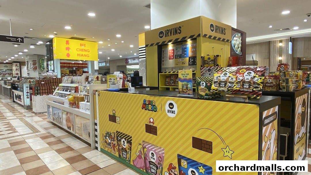 A retail stall featuring Irvins snacks with Super Mario branding and Bee Cheng Hiang products.