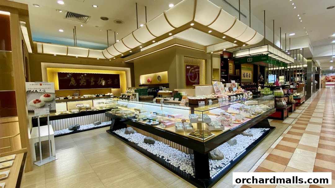 Interior view of a well-lit confectionery shop with display cases filled with sweets.
