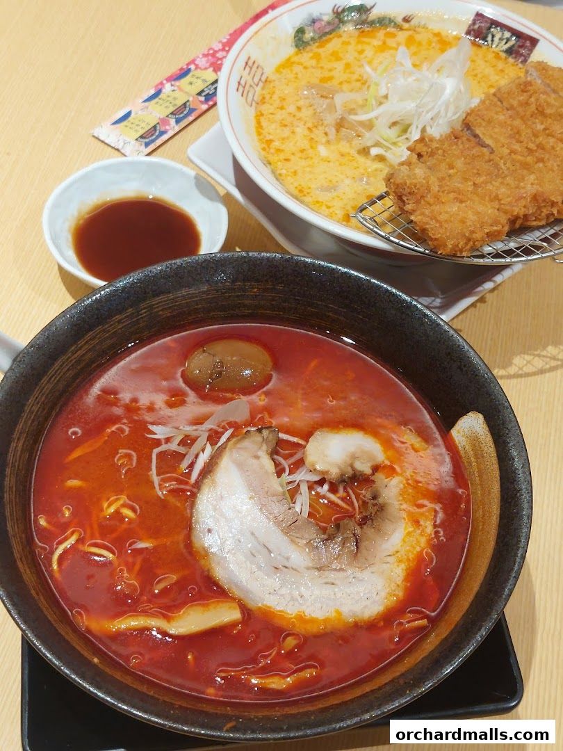 Two bowls of ramen, one with pork cutlet, and a side of dipping sauce.