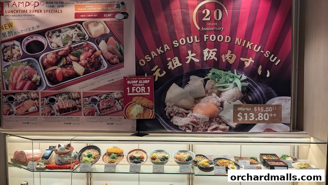 A display of Japanese bento boxes, ramen, and other dishes at Tampopo restaurant.
