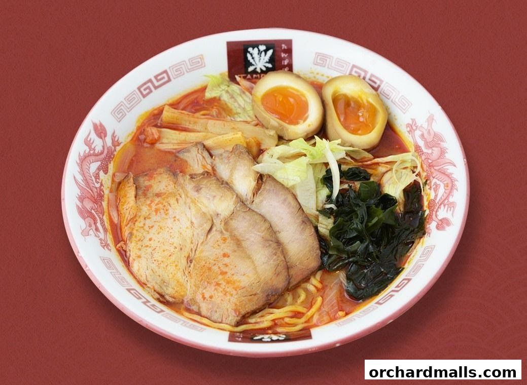 A delicious bowl of ramen with chashu pork, soft-boiled eggs, and vegetables.