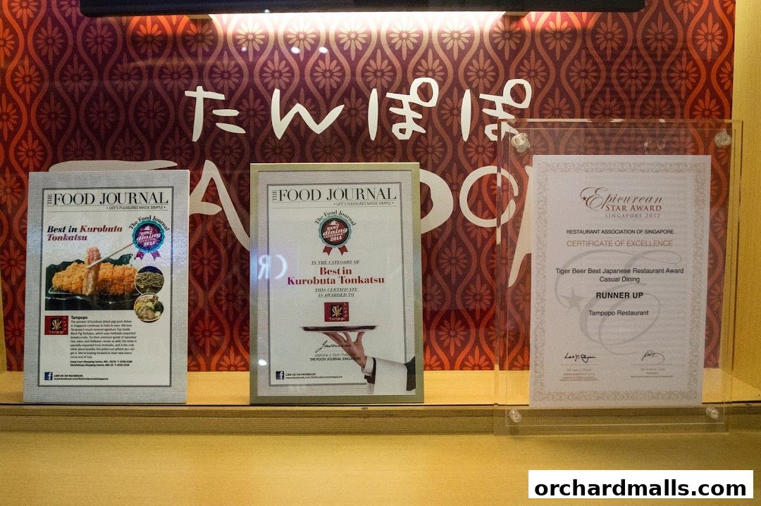 Awards and accolades displayed for Tampopo restaurant, highlighting their Kurobuta Tonkatsu.