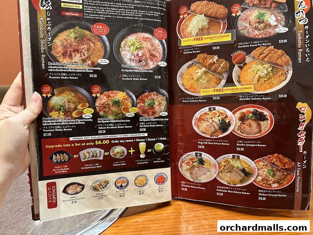 A menu from Tampopo featuring various ramen dishes, tonkatsu, and toppings.