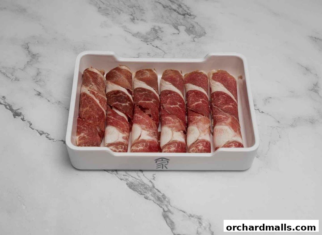 A white tray filled with six rolled slices of marbled raw meat.
