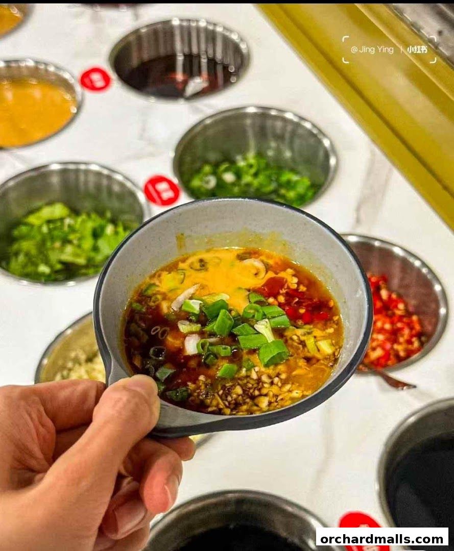 A hand holds a bowl of dipping sauce with various ingredients, surrounded by other condiment bowls.