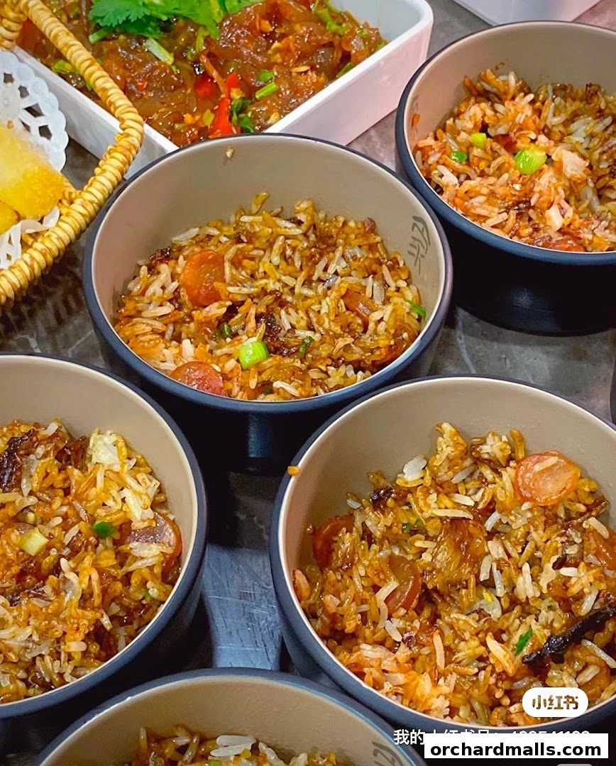 Bowls of savory fried rice with sausage and vegetables, served with a side dish.