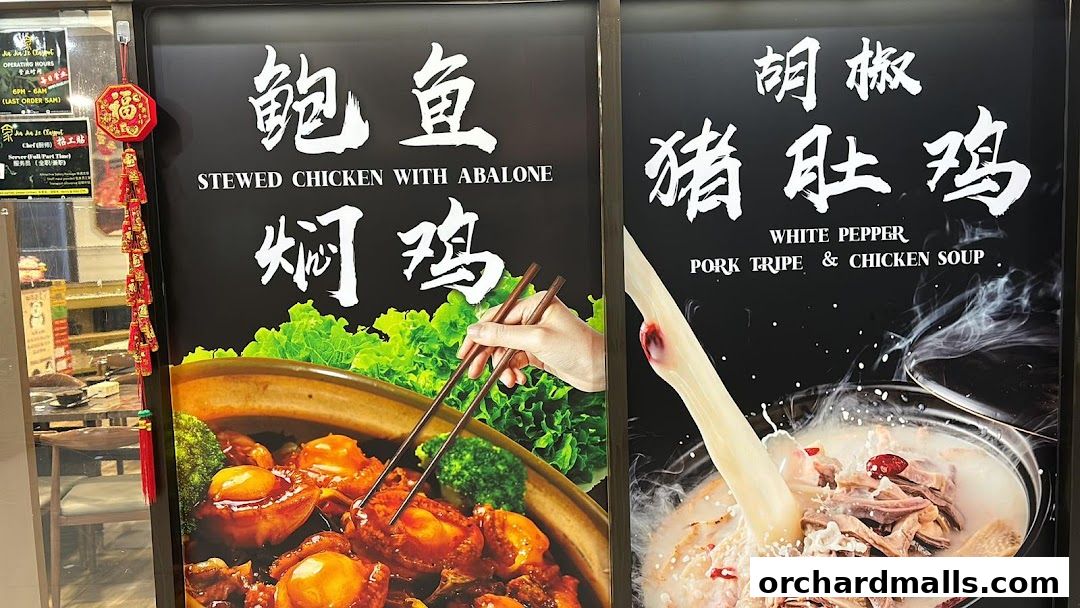 A display board showcasing two signature dishes: Stewed Chicken with Abalone and White Pepper Pork Tripe & Chicken Soup.