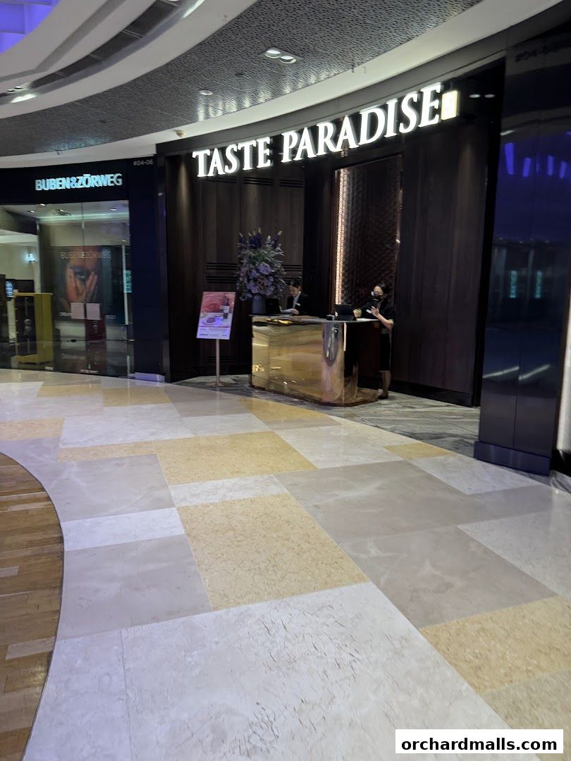 The entrance of Taste Paradise restaurant with staff at the reception desk.