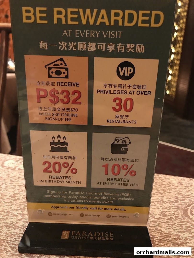 A sign detailing rewards and rebates for the Paradise Gourmet Rewards membership program.