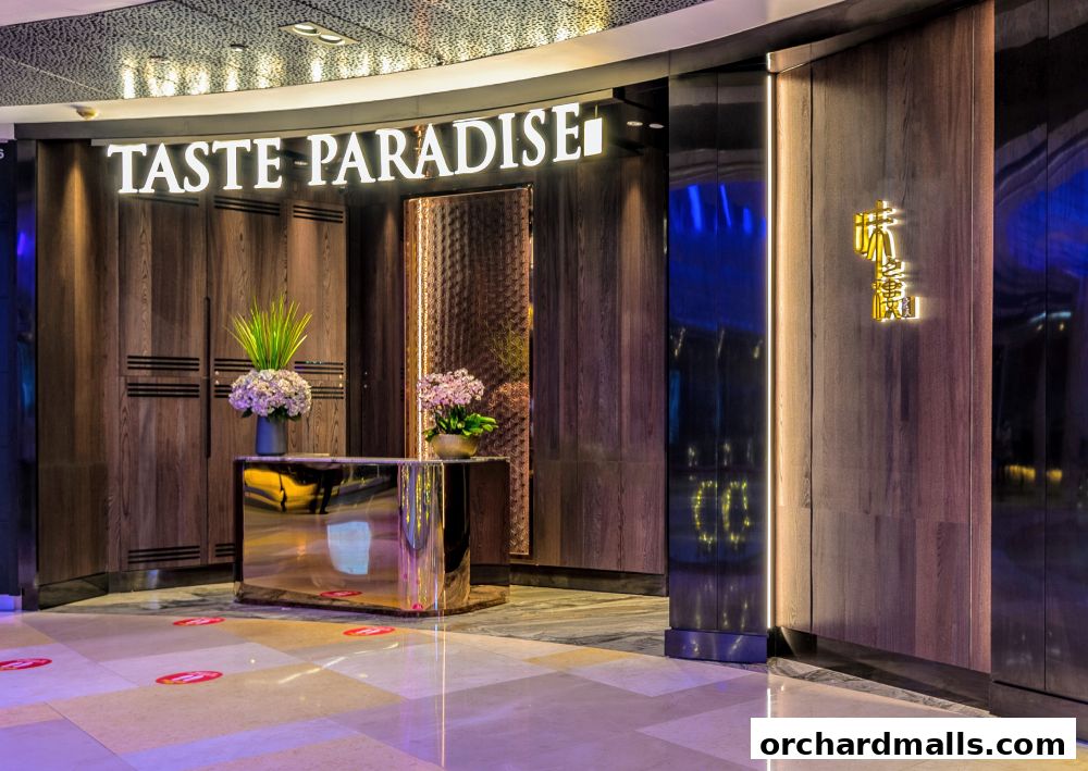 The elegant entrance of Taste Paradise restaurant with illuminated signage and floral decor.