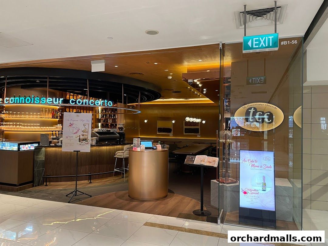 The elegant entrance of 'tcc - The Connoisseur Concerto' cafe with a display of high tea items.