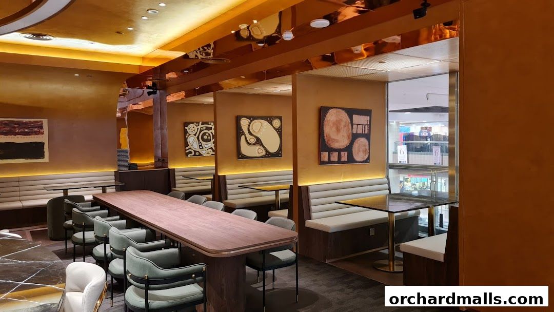 Interior view of a modern restaurant with booth seating, tables, and artwork.