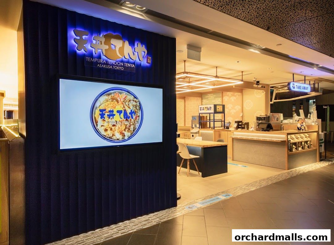 The entrance of Tenya ION Orchard, a Japanese tempura restaurant, with a large screen displaying their signature dish.