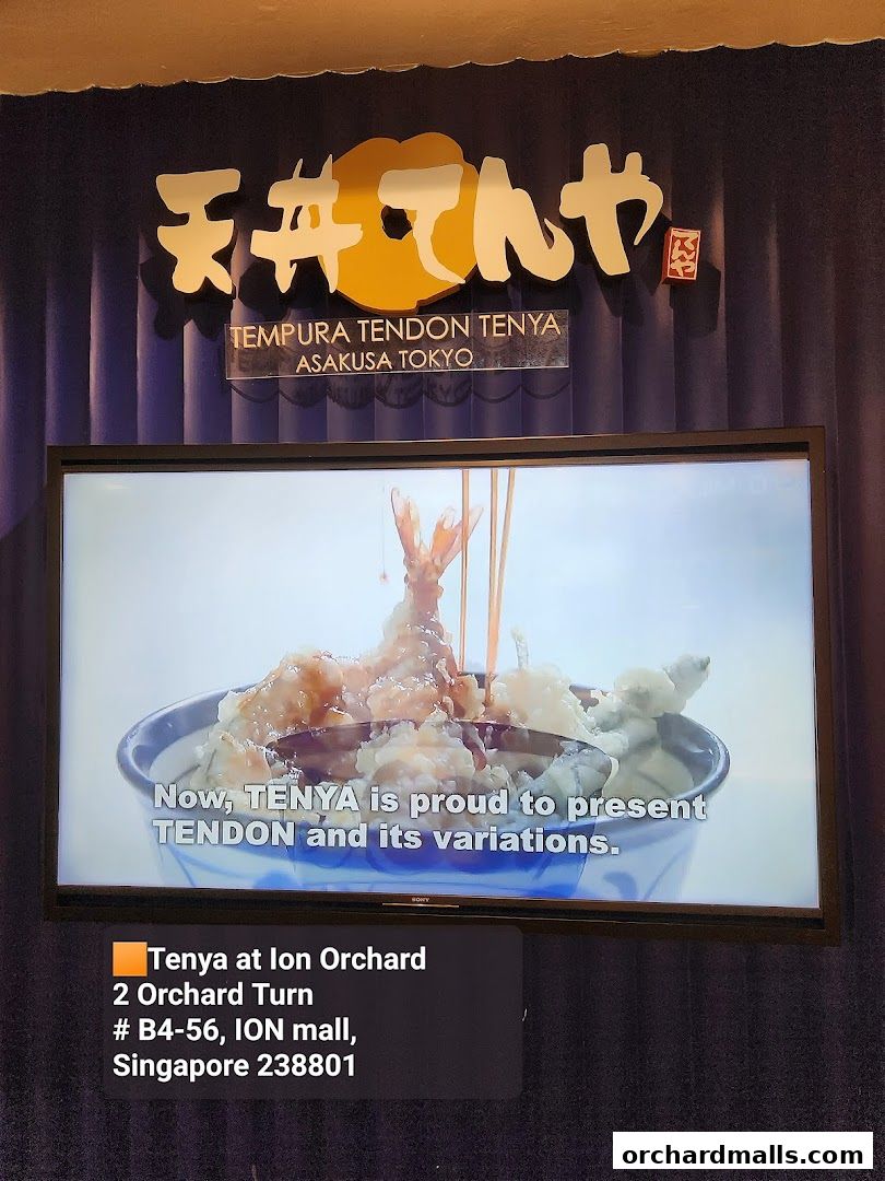 A screen displays a video of tempura being drizzled with sauce, with the restaurant's name and address below.