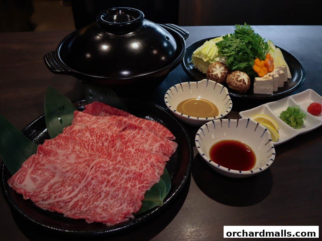 A spread of Japanese hot pot ingredients including thinly sliced beef, vegetables, tofu, and dipping sauces.