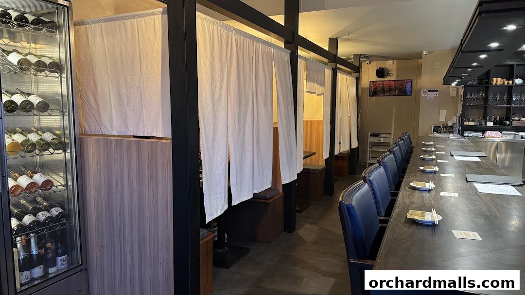 Interior of Tetsu Japanese Cuisine with private dining booths and a sushi bar.