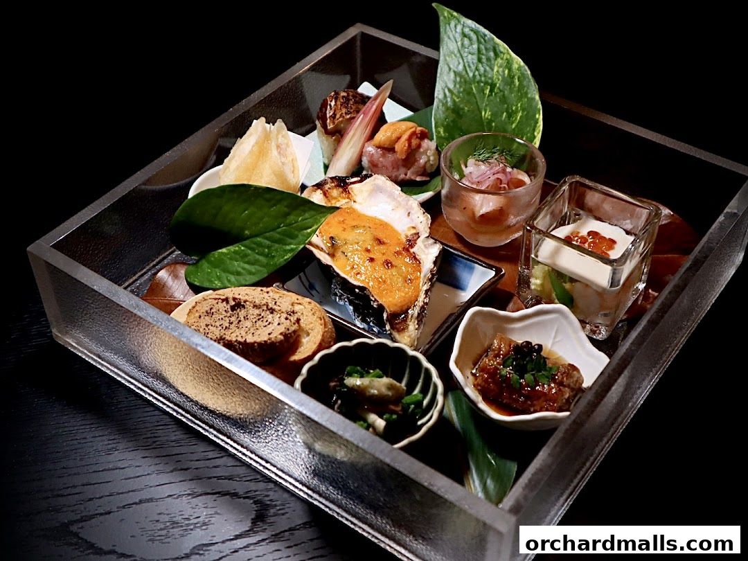 A beautifully presented Japanese cuisine platter with various small dishes and seafood.