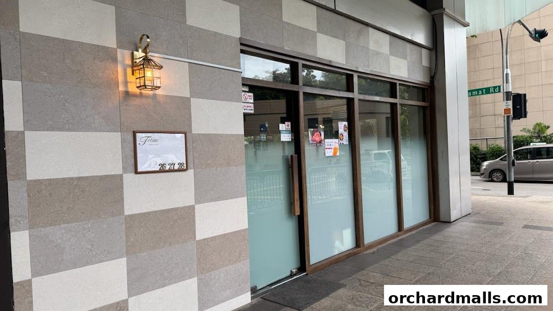 Exterior of Tetsu Japanese Cuisine with a sign and a decorative lamp.