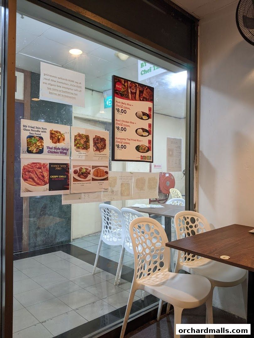 View of Thai Tantric Authentic Thai Cuisine shop entrance with menu displays and seating.