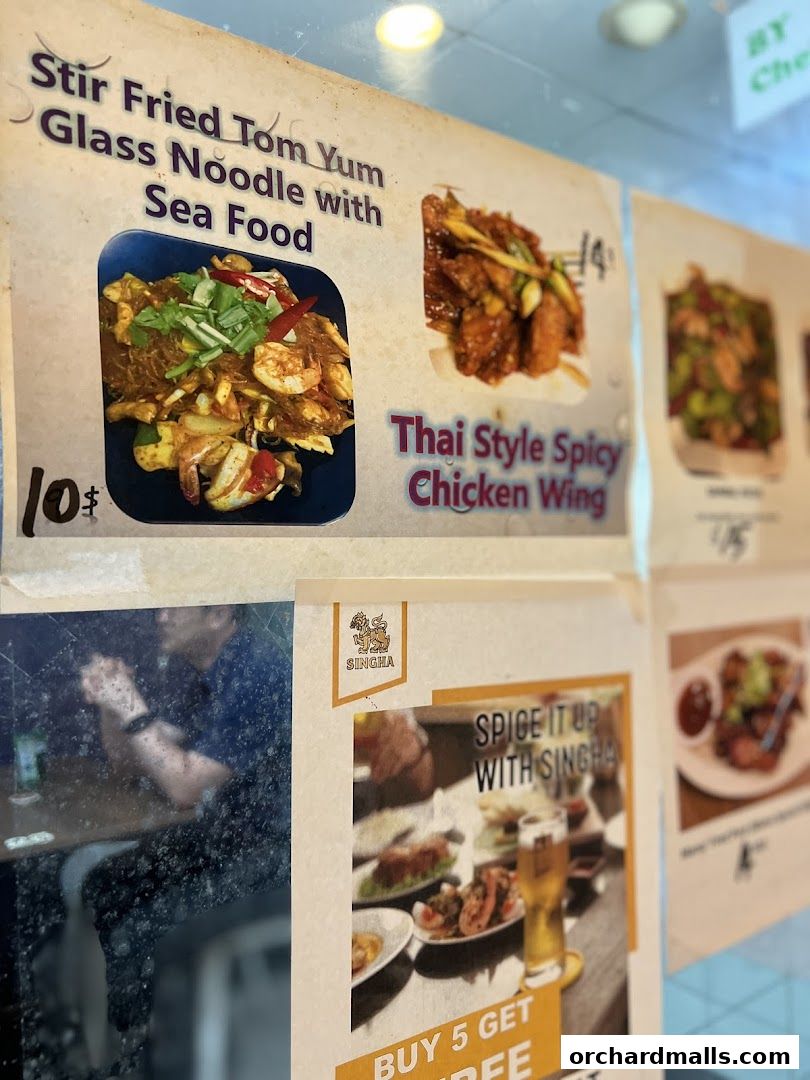 A menu board displaying Thai dishes with images and prices.