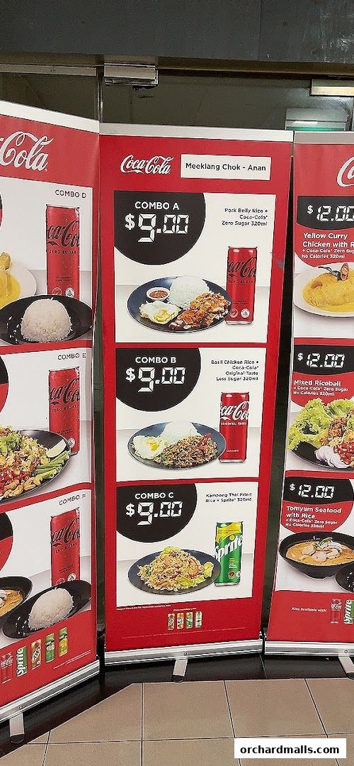 A display of combo meals from Meeklang Chok - Anan, featuring Thai dishes and Coca-Cola products.