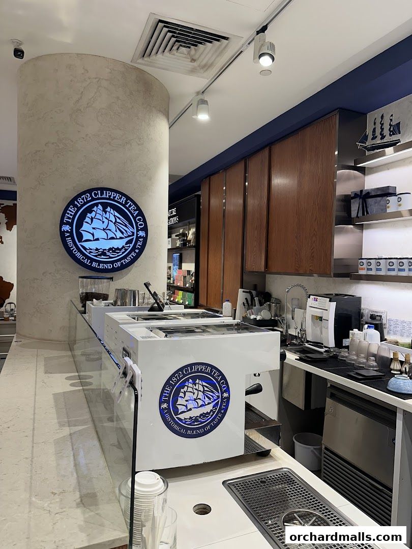 Interior view of The 1872 Clipper Tea Co. shop with a counter and branding.