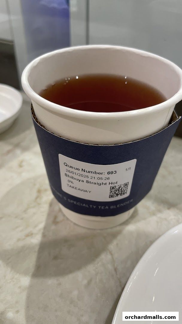 A cup of hot tea with a sleeve showing order details from The 1872 Clipper Tea Co.