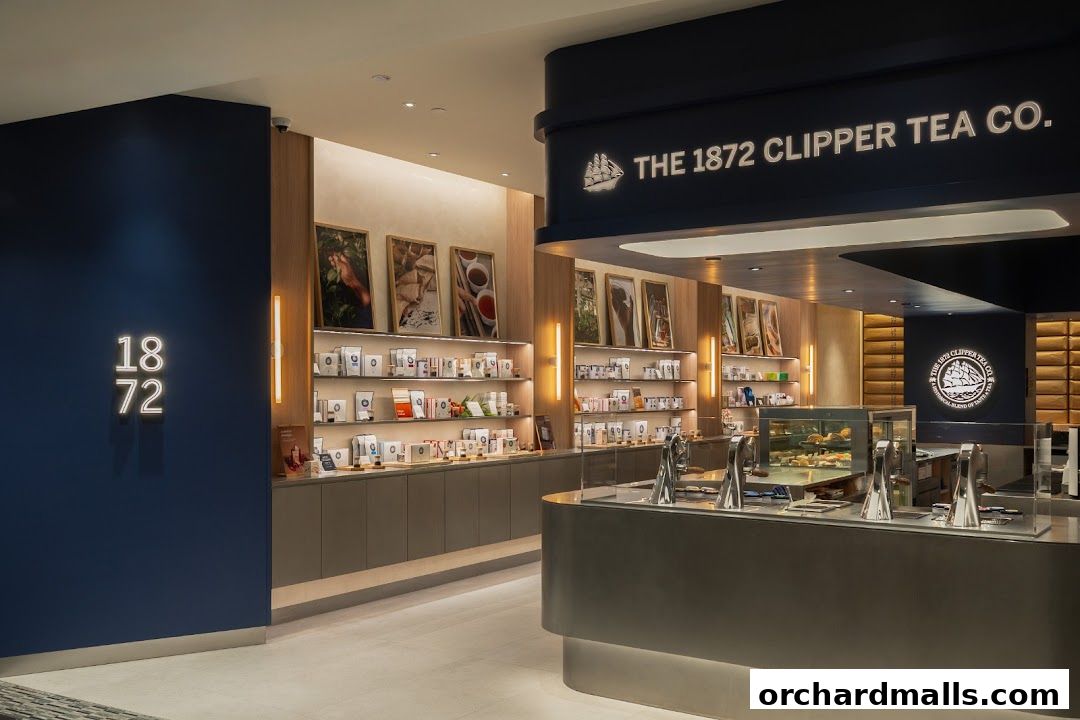 Interior view of The 1872 Clipper Tea Co. shop with shelves of tea products and a counter.