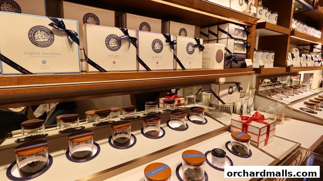 Shelves displaying various tea boxes and jars of loose leaf tea.