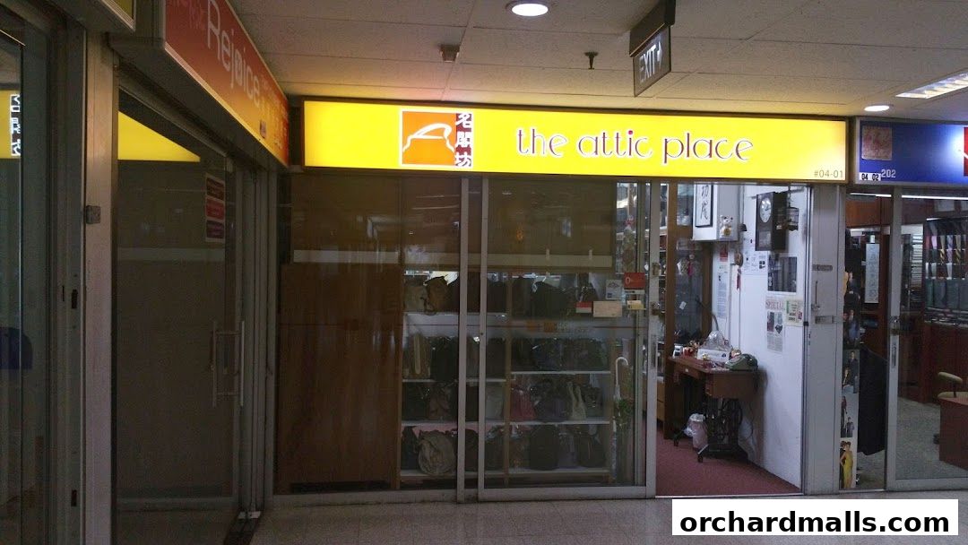 The Attic Place shop front with bags displayed in a window and a sewing machine inside.