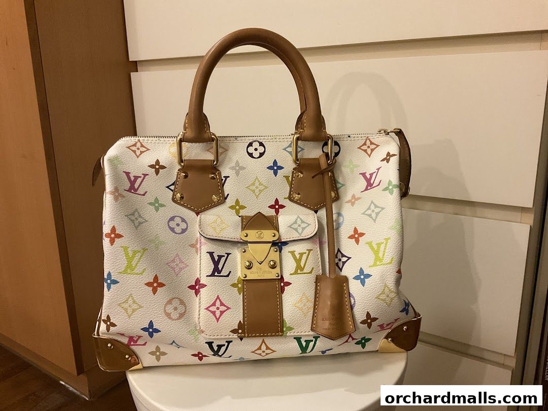 A white Louis Vuitton handbag with a colorful monogram pattern and brown leather trim.