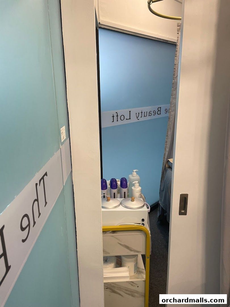 Interior view of The Beauty Loft, showing a trolley with beauty equipment and frosted glass door.