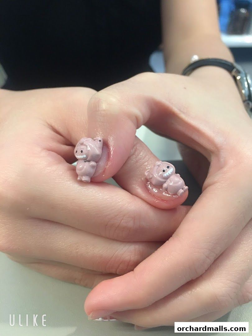 Close-up of hands with adorable pink bear nail art from The Beauty Loft.