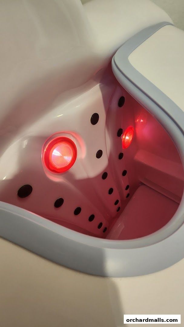 Close-up of a modern bathtub with red LED lights and jets.
