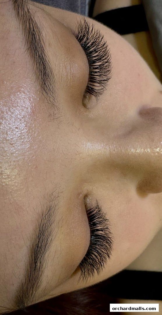 Close-up of a person's eyes with dramatic, voluminous eyelash extensions.